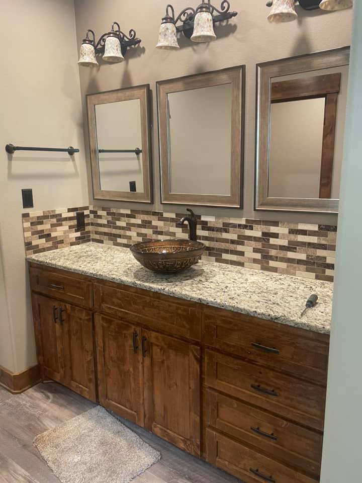Mosaic tile vanity backsplash with granite countertop installed in Richland Springs TX by Heart of Texas Flooring
