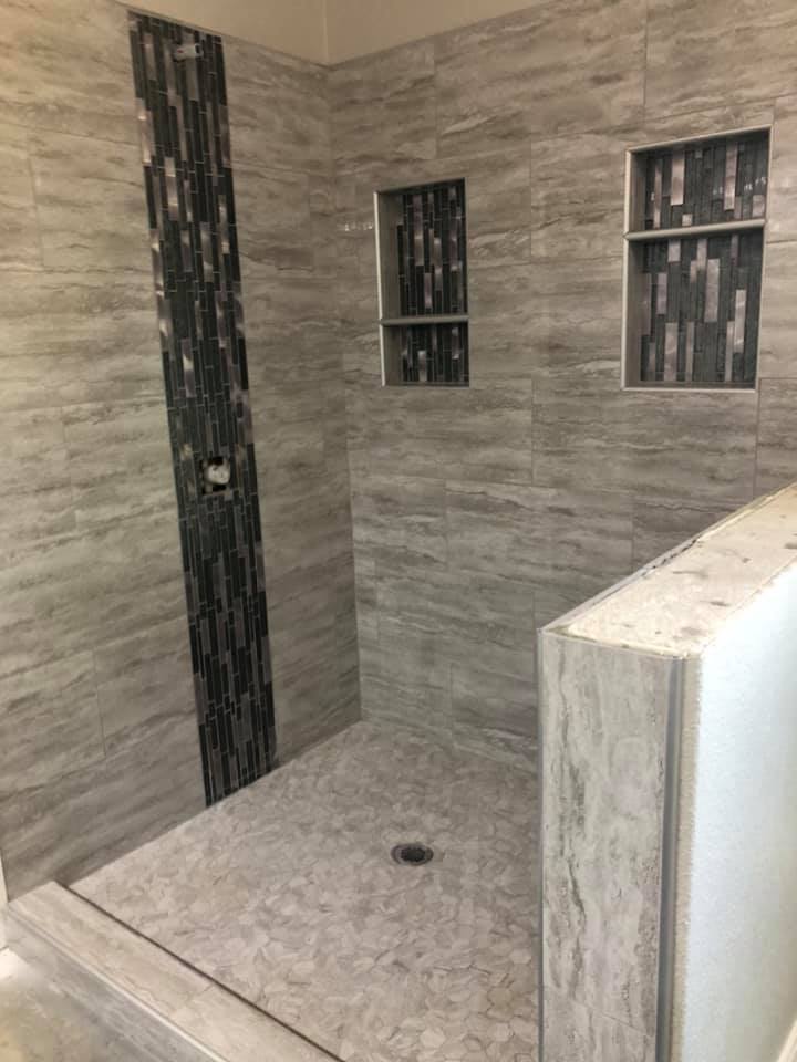 Custom wood-look tile walk-in shower installed by Heart of Texas Flooring